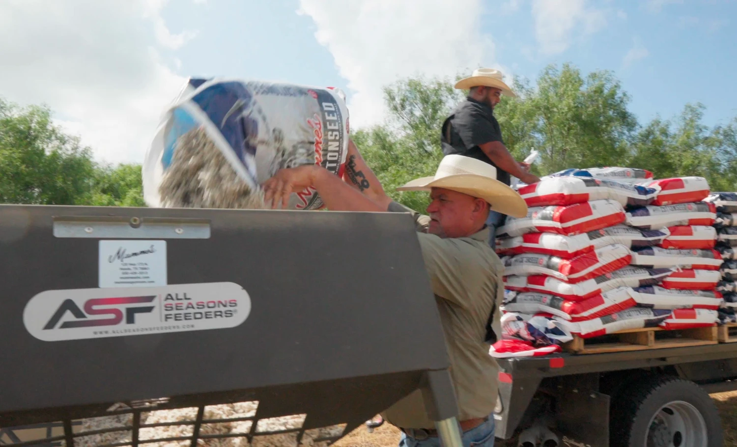 A ranch hand pouring Mumme's cottonseed into an All Seasons protein feeder