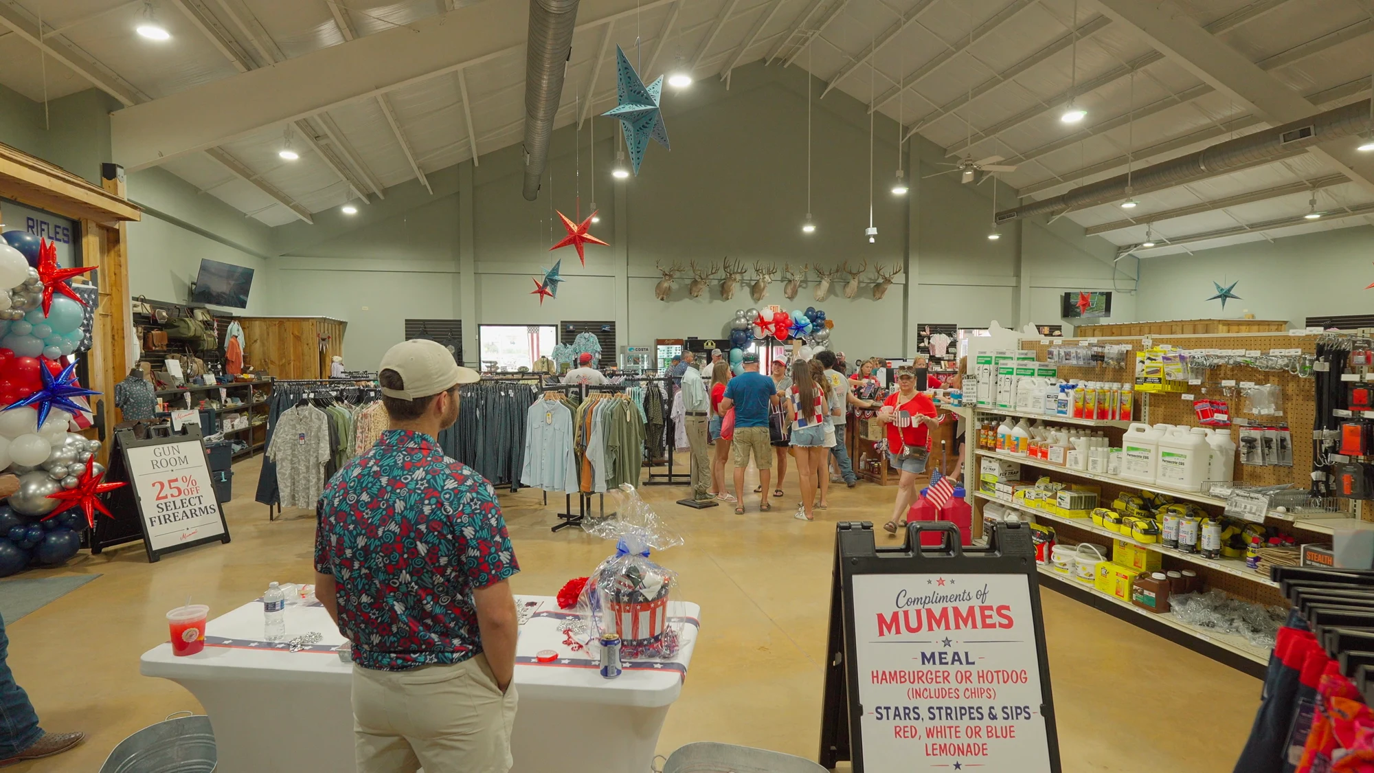 A customer in a straw cowboy hat reaching for a lariat rope on the tack wall at Mumme’s