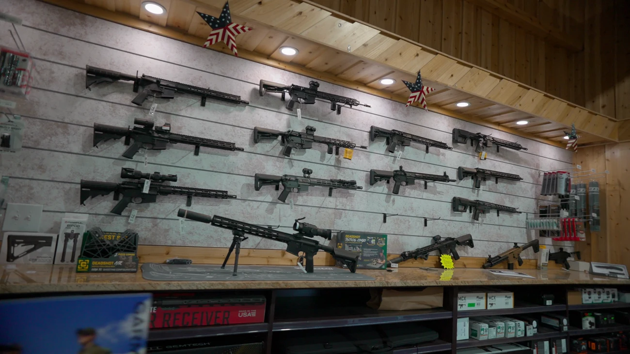 Modern sporting rifles displayed on the slat wall of the Mumme's gun room