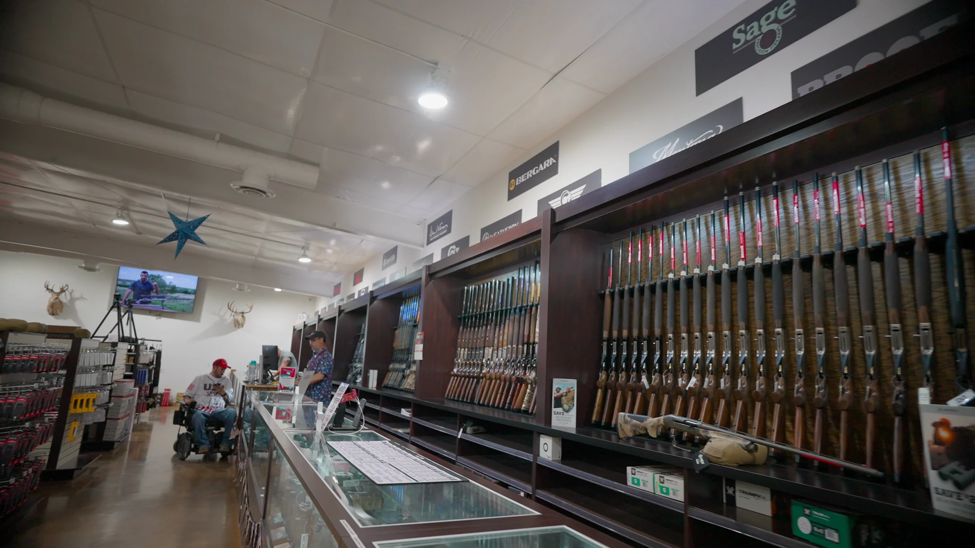 The length of the gun room at Mumme's Hondo store, rifles racked along the wall above the glass counter