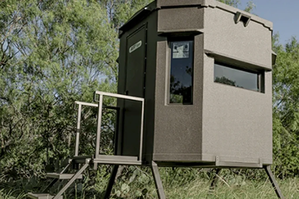 An All Seasons tower blind on stands in the South Texas brush, with stairs and a rail